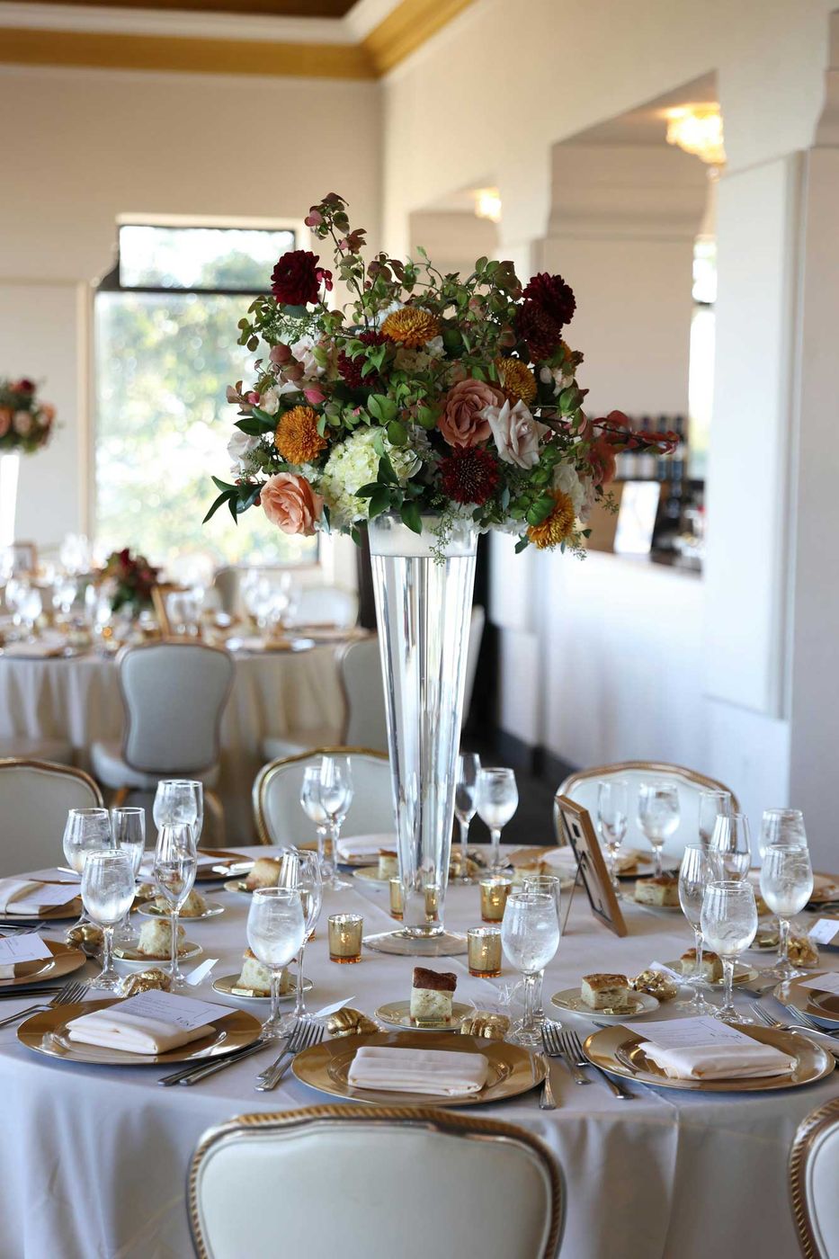 Tall autumn centerpiece above a reception table