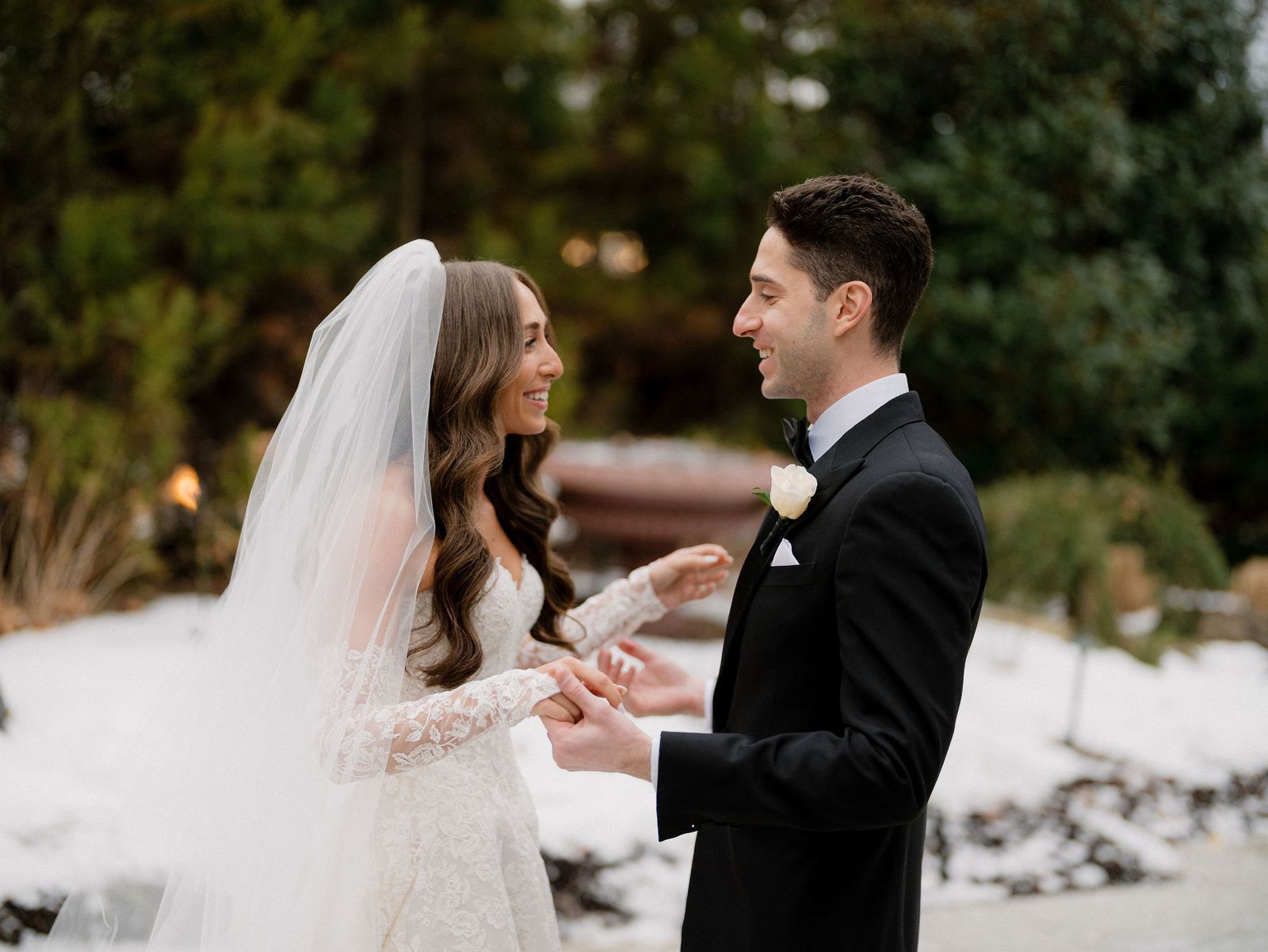 Bride and groom sharing a first look outdoors in the snow