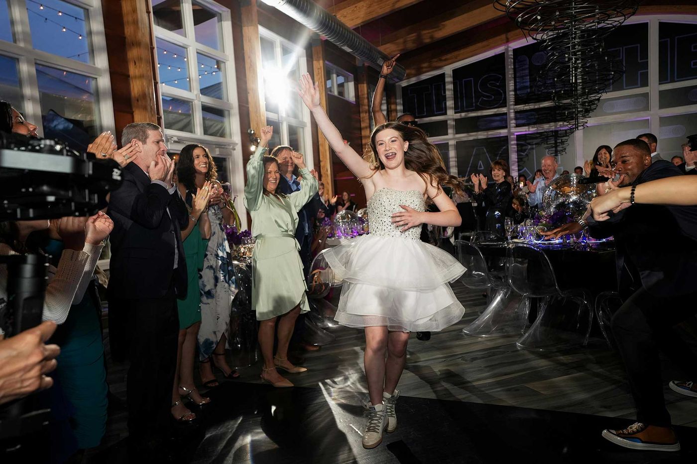 Bat mitzvah girl dancing with guests