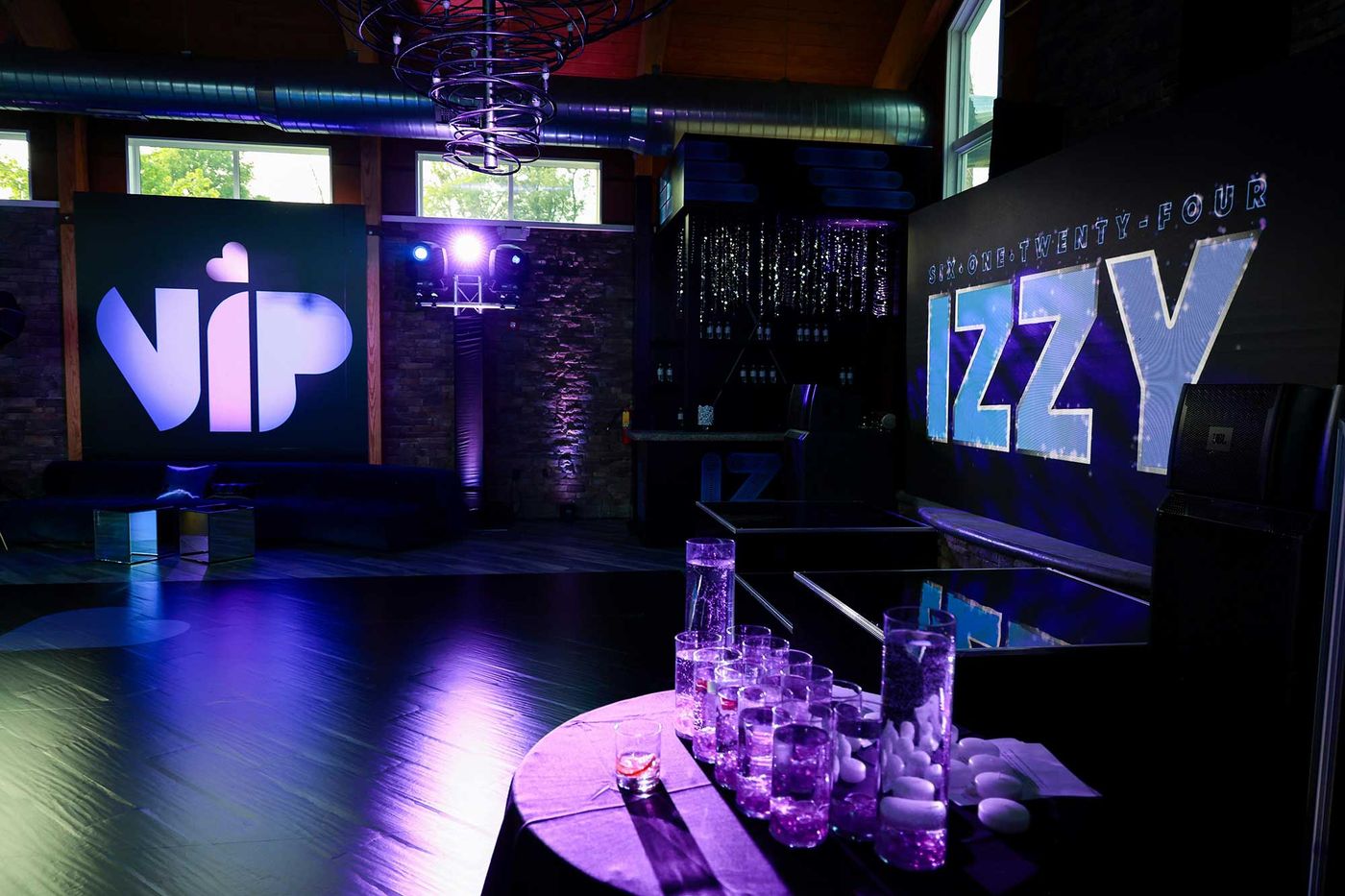 VIP lounge with a backlit sign and clear furniture
