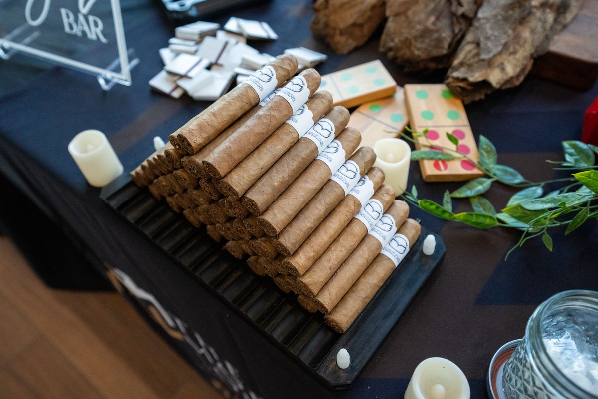 Cigars with custom printed bands on a wooden tray